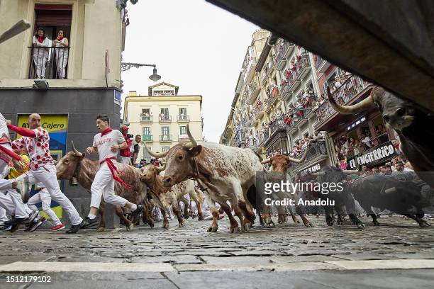 People take part in the traditional 'encierro' of the San Fermin Festival in Pamplona, Spain on July 07, 2023. The bull-running fiesta is held...