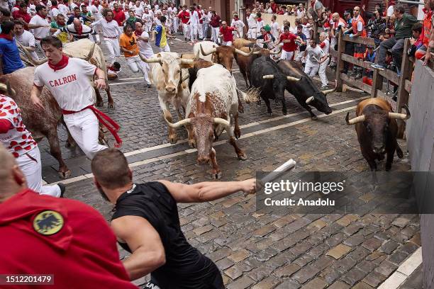 People take part in the traditional 'encierro' of the San Fermin Festival in Pamplona, Spain on July 07, 2023. The bull-running fiesta is held...