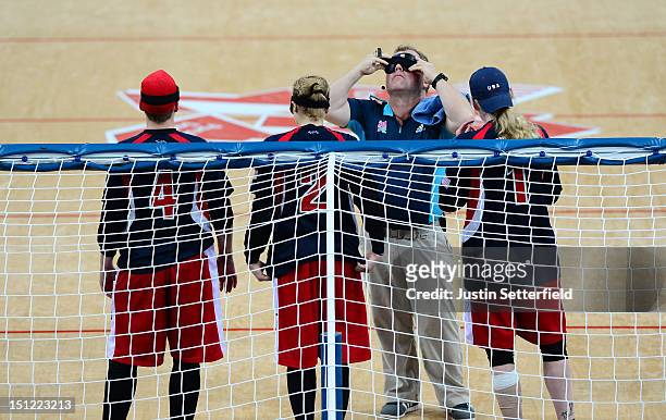 Technical offical tests the black-out goggles during the Women's Team Goalball preliminary round match between the United States and Canada on Day 6...