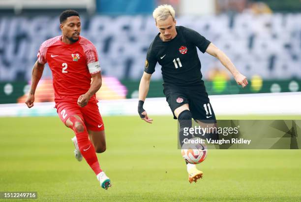 Liam Millar of Canada battles for the ball with Mickael Alphonse of Guadeloupe during a 2023 Concacaf Gold Cup match at BMO Field on June 27, 2023 in...