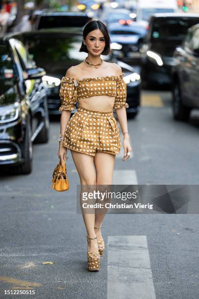 Heart Evangelista is seen wearing cropped top, shorts with print, brown bag, platform shoes outside Giambattista Valli during the Haute Couture...
