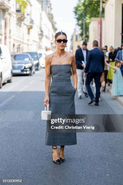 Camila Coelho is seen wearing grey off shoulder dress, white bucket bag outside Dior during the Haute Couture Fall/Winter 2023/2024 as part of Paris...