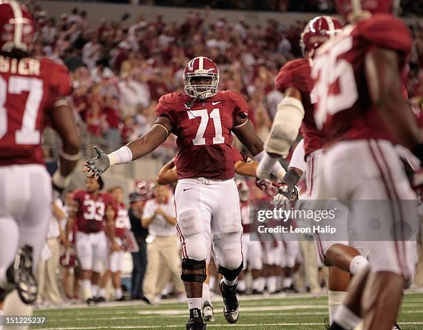 Cyrus Kouandjio of the University of Alabama reacts after a big stop during the game against the University of Michigan at Cowboys Stadium on...