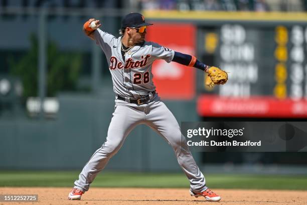 Javier Baez of the Detroit Tigers throws to first base after fielding a ground ball in a game against the Colorado Rockies at Coors Field on July 2,...