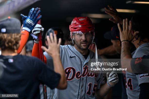 Jake Marisnick of the Detroit Tigers celebrates in the dugout with a homerun helmet and hockey stick after hitting an eighth inning grand slam...