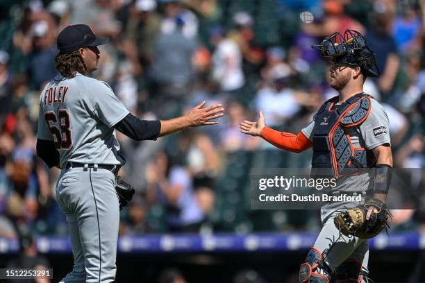 Jason Foley and Jake Rogers of the Detroit Tigers shake hands after sealing the win in a game against the Colorado Rockies at Coors Field on July 2,...