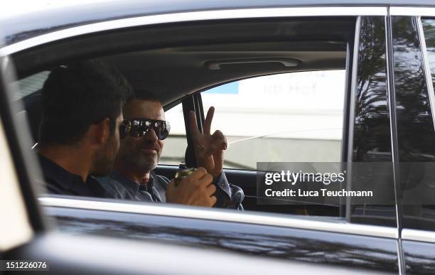 George Michael and Fadi Fawaz arrive at Airport Vienna on September 4, 2012 in Vienna, Austria.