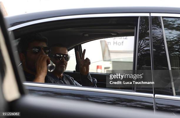 George Michael and Fadi Fawaz arrive at Airport Vienna on September 4, 2012 in Vienna, Austria.
