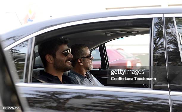 George Michael and Fadi Fawaz arrive at Airport Vienna on September 4, 2012 in Vienna, Austria.