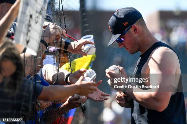 Spencer Torkelson of the Detroit Tigers signs autographs for fans in the stands after a game against the Colorado Rockies at Coors Field on July 2,...