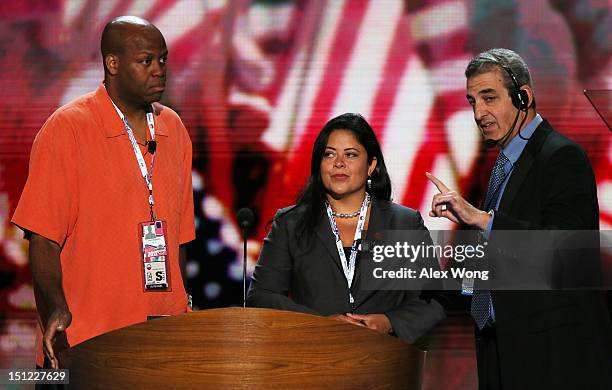 First lady Michelle Obama's brother Craig Robinson and U.S. President Barack Obama's sister Dr. Maya Kassandra Soetoro-Ng stand at the podium with...
