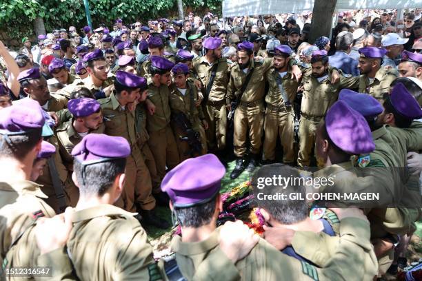 Israeli soldiers attend the funeral of a fellow soldier, killed the day before near Kedumim settlement, at the Mount Herzl cemetery in Jerusalem, on...