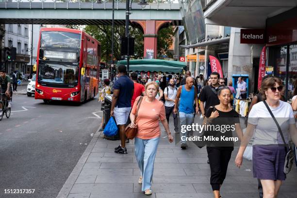 Street scene on Brixton Road where people wait for public transport buses in the diverse community of Brixton on 22nd June 2023 in London, United...