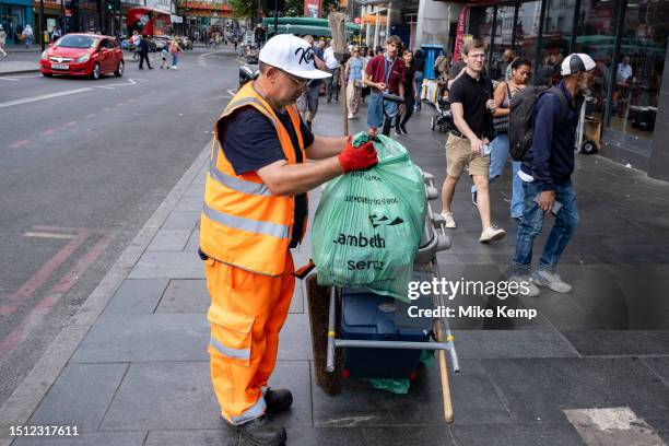 Street cleaner in the diverse community of Brixton on 22nd June 2023 in London, United Kingdom. Brixton is a district in south London, England, in...