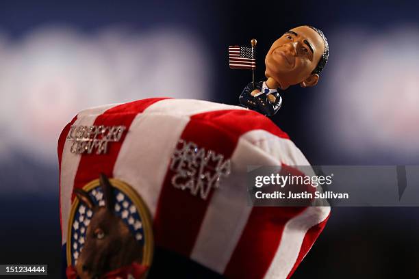 Person wears a hat with a bobblehead of Democratic presidential candidate, U.S. President Barack Obama during day one of the Democratic National...