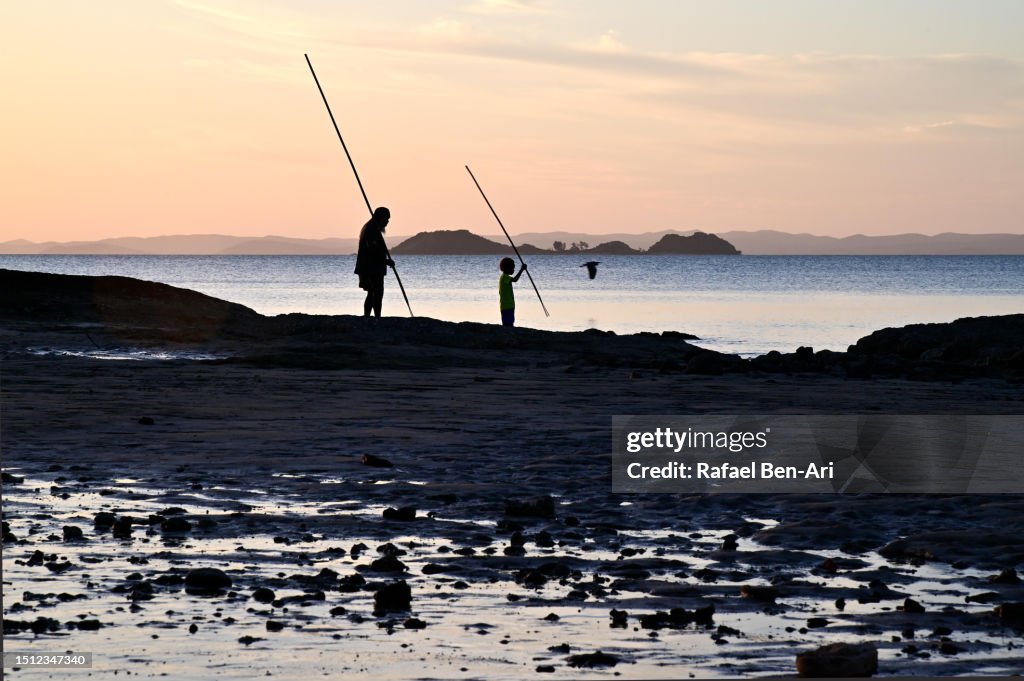 First nation Australian aboriginal people using spears to hunt seafood in Cape York Queensland Australia