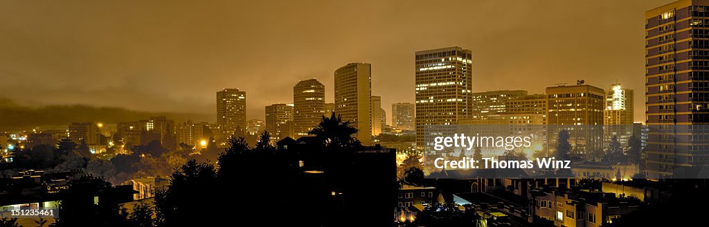 Oakland skyline in fog at night