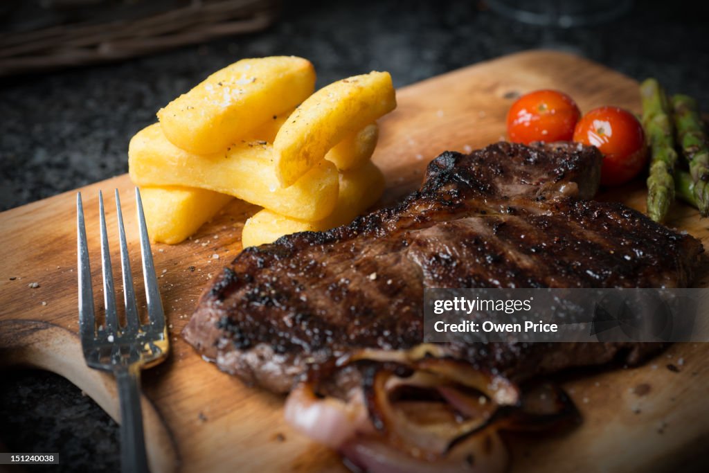 Rustic steak dinner on a wooden board