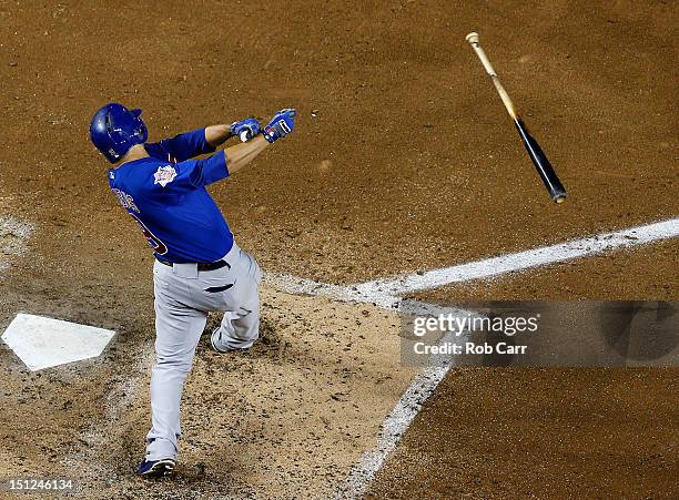 David DeJesus of the Chicago Cubs lets go of his bat while swinging at a pitch during the sixth inning against the Washington Nationals at Nationals...