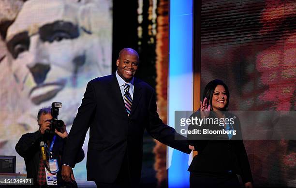 Craig Robinson, brother of First Lady Michelle Obama, left, and Maya Soetoro-Ng, sister of U.S. President Barack Obama, wave after speaking at the...