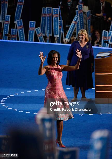 First lady Michelle Obama waves on stage after being introduced by Elaine Brye during day one of the Democratic National Convention at Time Warner...