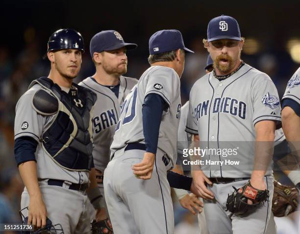Dale Thayer of the San Diego Padres leaves the mound in front of Manager Bud Black, Yasmani Grandal and Chase Headley after giving up a run for a 2-1...
