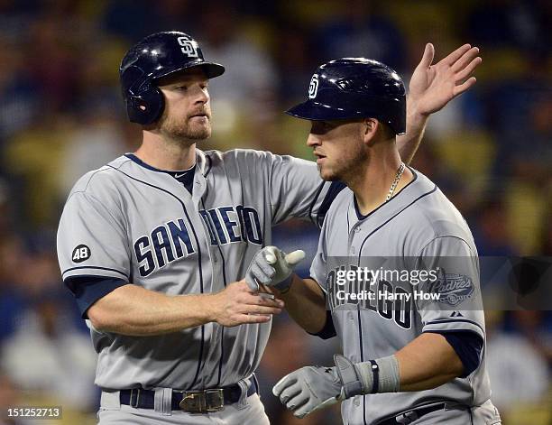 Yasmani Grandal of the San Diego Padres celebrates his two run homerun with Chase Headley for a 3-3 tie against the Los Angeles Dodgers during the...