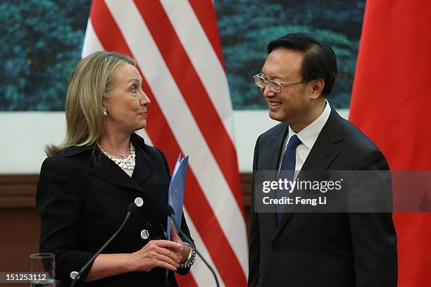 Chinese Foreign Minister Yang Jiechi talks with US Secretary of State Hillary Clinton after attending the press conference at the Great Hall of the...