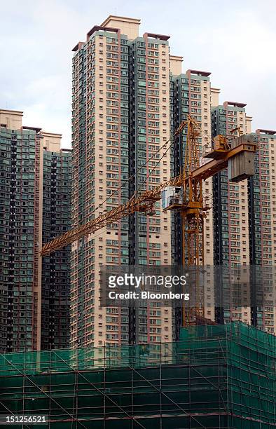 Residential tower blocks stand behind a construction site in the Tseung Kwan O area of the New Territories in Hong Kong, China, on Tuesday, Sept. 4,...