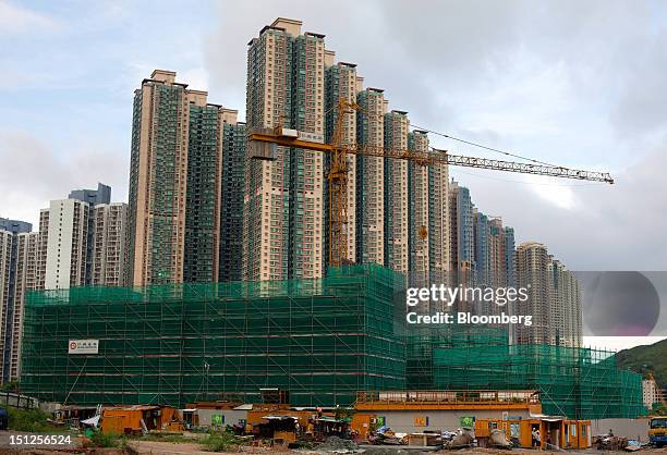 Residential tower blocks stand behind a construction site in the Tseung Kwan O area of the New Territories in Hong Kong, China, on Tuesday, Sept. 4,...