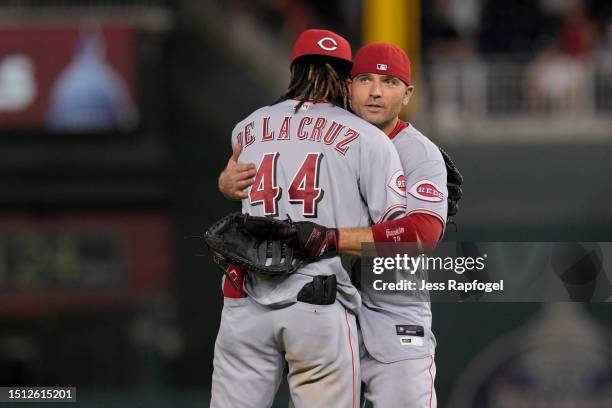 Elly De La Cruz and Joey Votto of the Cincinnati Reds hug after winning against the Washington Nationals at Nationals Park on July 03, 2023 in...