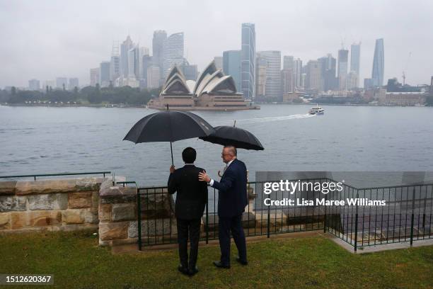 Australian Prime Minister Anthony Albanese stands with Indonesian President Joko Widodo as they look out towards Sydney Harbour from Admiralty House...