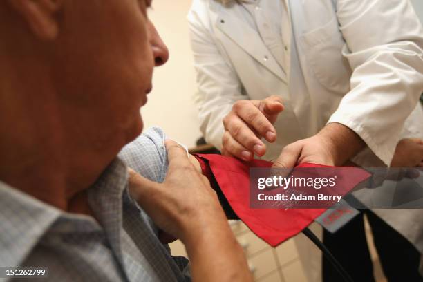 Doctor checks a patient's blood pressure on September 5, 2012 in Berlin, Germany. Doctors in the country are demanding higher payments from health...