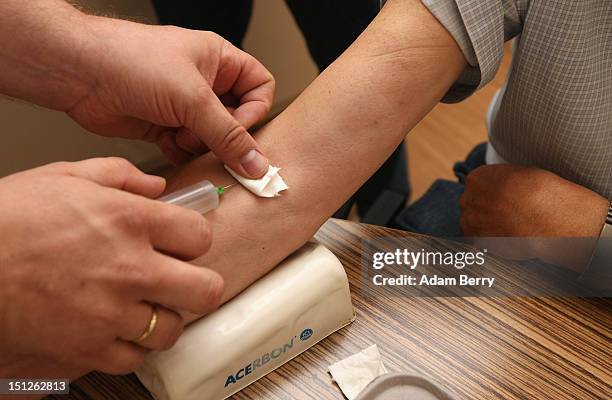 Doctor takes blood from a patient on September 5, 2012 in Berlin, Germany. Doctors in the country are demanding higher payments from health insurance...