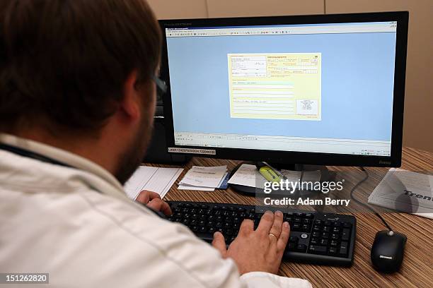 Doctor prepares a prescription on a computer screen for a patient on September 5, 2012 in Berlin, Germany. Doctors in the country are demanding...