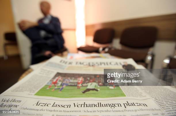 Newspaper headline about doctors breaking off talks with insurance companies is seen in a doctor's waiting room on September 5, 2012 in Berlin,...