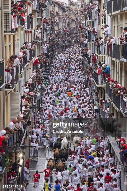 People take part in the traditional 'encierro' of the San Fermin Festival in Pamplona, Spain on July 07, 2023. The bull-running fiesta is held...