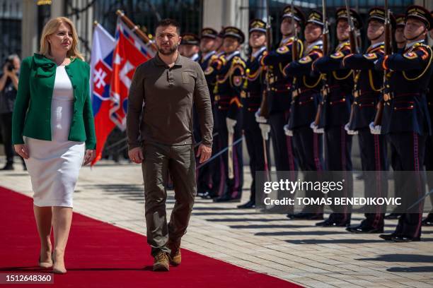 Slovak President Zuzana Caputova and Ukrainian President Volodymyr Zelensky review a military honour guard during an official welcoming ceremony in...