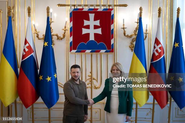 Slovak President Zuzana Caputova and Ukrainian President Volodymyr Zelensky shake hands at the Presidential Palace in Bratislava, Slovak Republic, on...
