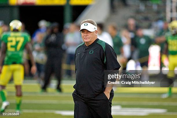 Head coach Chip Kelly of the Oregon Ducks watches warm ups against the Arkansas State Red Wolves on September 1, 2012 at Autzen Stadium in Eugene,...