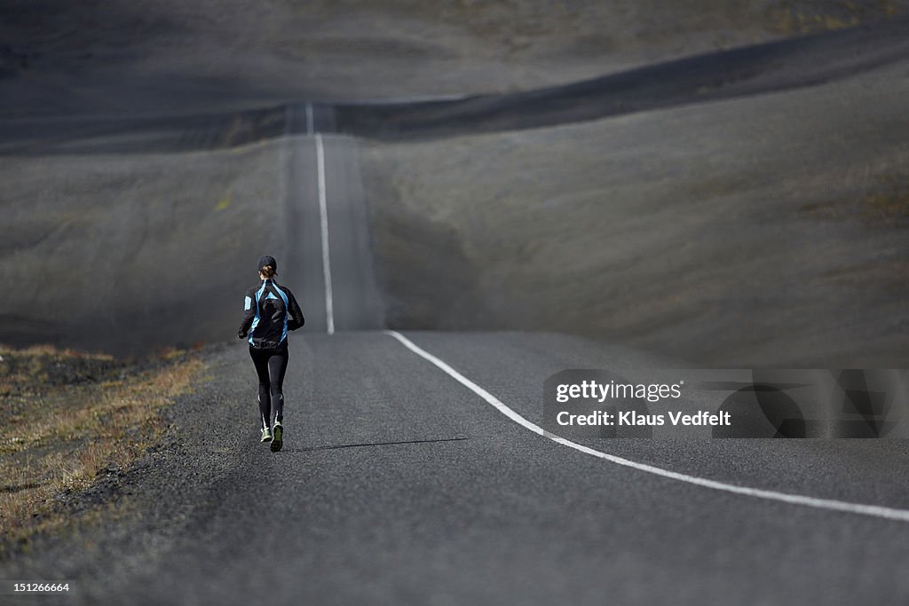 Runner on endless deserted road