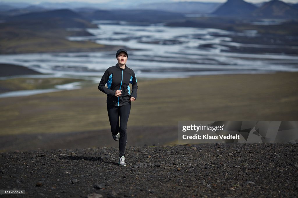 Woman running on lava gravel trail