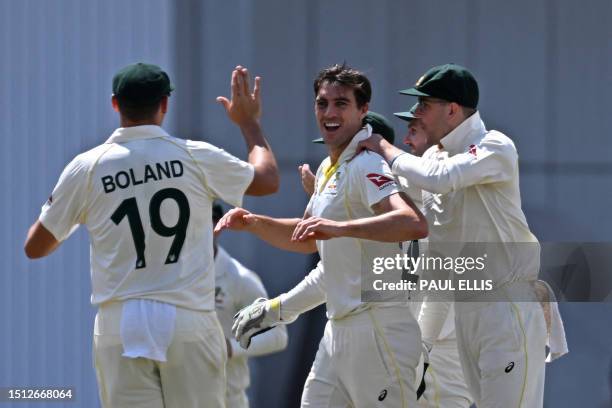 Australia's Pat Cummins celebrates with teammates after taking the wicket of England's Moeen Ali on day two of the third Ashes cricket Test match...