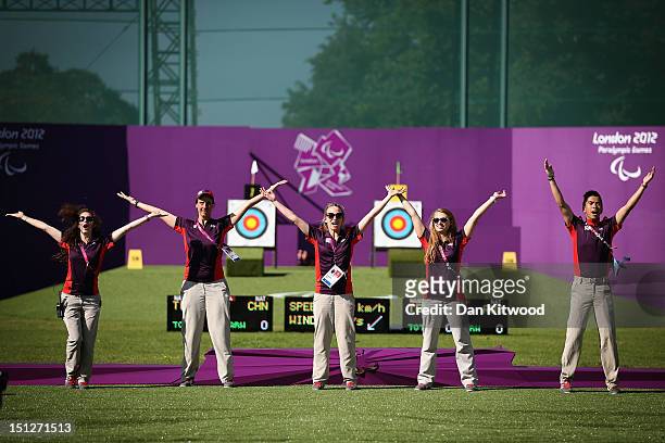 Paralympic volunteers dance on the archery range on day 7 of the London 2012 Paralympic Games at The Royal Artillery Barracks on September 5, 2012 in...