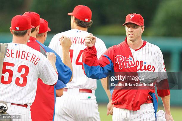 Roy Halladay of the Philadelphia Phillies greets teammates before the game against the Arizona Diamondbacks at Citizens Bank Park on August 4, 2012...