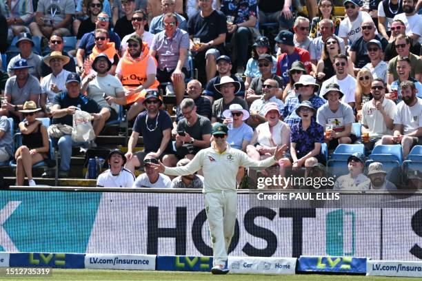 Australia's Steven Smith interacts with fans sitting in the Western Terrace while fielding on the boundary on day two of the third Ashes cricket Test...