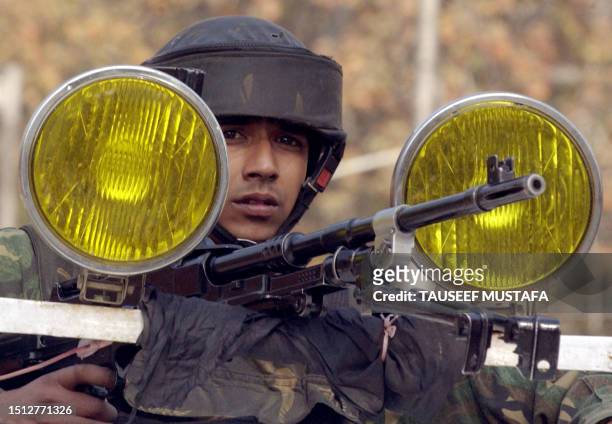 An Indian Central Reserve Police Force soldier guards outside the headquarters of the Jammu and Kashmi Bank following a car bomb blast in Srinagar,...