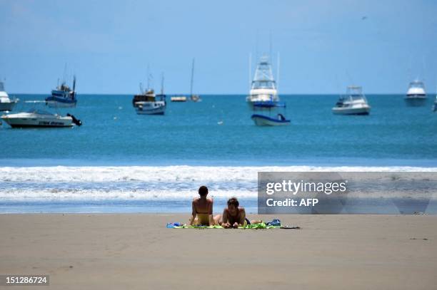 Tourists sunbath in San Juan del Sur beach, 140 km from Managua, during the tsunami alert issued in the Pacific coast following the earthquake that...