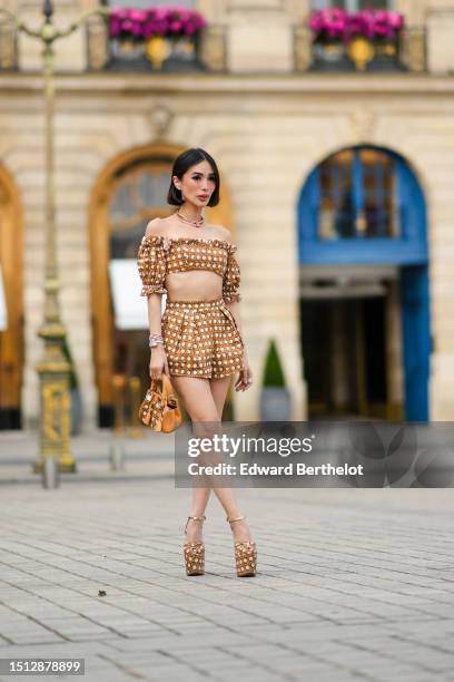 Heart Evangelista wears diamonds large earrings, a pink gold with large stones necklace, a pink gold and diamonds necklace from Bulgari, a white with...