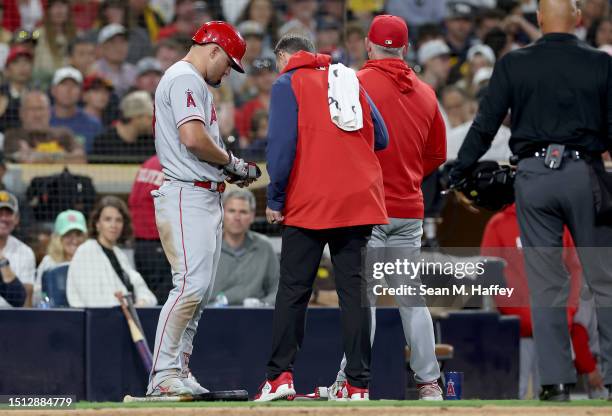 Manager Phil Nevin talks with Mike Trout of the Los Angeles Angels during his at bat during the eighth inning of a game against the San Diego Padres...